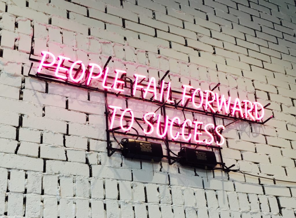 'people fail forward to success' on wall.
